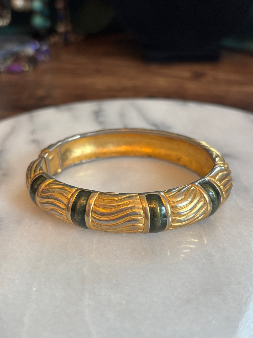 Monet Gold-Tone Wave Bangle with Green Accents